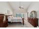 This primary bedroom features a ceiling fan and access to the lanai at 13806 Sumac Pl, Tampa, FL 33625