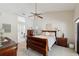Comfortable main bedroom with wooden furniture and a view of the ensuite bathroom at 13806 Sumac Pl, Tampa, FL 33625