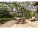 The home features an outdoor screened patio with an outdoor dining set, perfect for relaxing and entertaining at 13806 Sumac Pl, Tampa, FL 33625