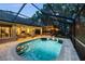 Enjoy this beautiful pool area with brick pavers, screened enclosure, and outdoor seating, perfect for evening relaxation at 13806 Sumac Pl, Tampa, FL 33625