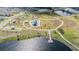 Aerial view of community park featuring a playground, walking paths, and scenic lake with pier at 14507 Woodland Spur Dr, Lithia, FL 33547