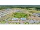 Wide aerial view of the community, showing the well-kept lawns, ponds, community pool, and many residences at 14507 Woodland Spur Dr, Lithia, FL 33547