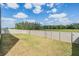 Spacious backyard featuring a large grassy area, a neutral privacy fence, and a tree line view at 14507 Woodland Spur Dr, Lithia, FL 33547