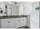 Bathroom vanity with granite countertop and glass-enclosed shower with white tile at 14507 Woodland Spur Dr, Lithia, FL 33547