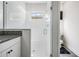 Glass shower features white tile and is adjacent to a sink with granite countertop at 14507 Woodland Spur Dr, Lithia, FL 33547
