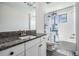 Bathroom features white cabinets, gray granite countertops, and shower/tub combination at 14507 Woodland Spur Dr, Lithia, FL 33547