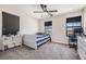 Neutral bedroom with a single bed, desk, and a ceiling fan at 14507 Woodland Spur Dr, Lithia, FL 33547