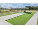 Community area with Bocce ball, picnic shelter, playground and green space, perfect for outdoor activities at 14507 Woodland Spur Dr, Lithia, FL 33547