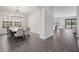 Dining room with a long table, seating for ten, decorative lighting and a view to an outdoor pool at 14507 Woodland Spur Dr, Lithia, FL 33547