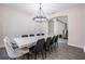 Dining room featuring modern chandelier, large table with seating for ten, and hardwood floors at 14507 Woodland Spur Dr, Lithia, FL 33547