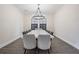 A dining room showcases a long table, seating for ten, a decorative light, and gray hardwood floors at 14507 Woodland Spur Dr, Lithia, FL 33547