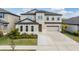 Charming two-story home with a three-car garage, manicured lawn, and inviting curb appeal at 14507 Woodland Spur Dr, Lithia, FL 33547