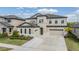 Stunning two-story home boasts a three-car garage and well-maintained landscaping, adding curb appeal at 14507 Woodland Spur Dr, Lithia, FL 33547