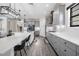 Spacious kitchen with gray cabinets, stainless steel appliances, and a large island, flowing into the dining area at 14507 Woodland Spur Dr, Lithia, FL 33547