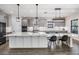 Open concept kitchen with gray cabinets, a large island, pendant lights, and stainless appliances at 14507 Woodland Spur Dr, Lithia, FL 33547