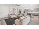 Bright living room with an open layout, modern furniture and views of the backyard and kitchen at 14507 Woodland Spur Dr, Lithia, FL 33547