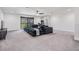 Living Room featuring a large couch and access to a covered patio at 14507 Woodland Spur Dr, Lithia, FL 33547