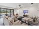 Cozy living room with neutral furniture, ceiling fan, gray floors, access to outdoor pool at 14507 Woodland Spur Dr, Lithia, FL 33547