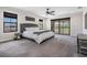 Main bedroom featuring a bed with a tufted headboard and sliding door access to a covered patio at 14507 Woodland Spur Dr, Lithia, FL 33547