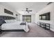 Main bedroom featuring a bed with a tufted headboard and sliding door access to a covered patio at 14507 Woodland Spur Dr, Lithia, FL 33547