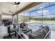 Outdoor patio seating area with a view of the pool and backyard, perfect for relaxing and entertaining at 14507 Woodland Spur Dr, Lithia, FL 33547