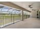 Spacious screened-in patio, complete with ceiling fans, exercise equipment, and scenic outdoor views at 14507 Woodland Spur Dr, Lithia, FL 33547