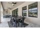Covered patio with ceiling fans, outdoor dining, and a poolside view, creating an inviting atmosphere at 14507 Woodland Spur Dr, Lithia, FL 33547