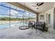 Inviting outdoor pool area with lounge seating, a unique hanging chair, and picturesque views at 14507 Woodland Spur Dr, Lithia, FL 33547