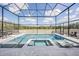 Stunning pool and spa with sun loungers, enclosed within a screened lanai offering expansive views at 14507 Woodland Spur Dr, Lithia, FL 33547