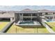 Aerial view of the screened-in pool and backyard with a soccer net and several chairs for lounging at 14507 Woodland Spur Dr, Lithia, FL 33547