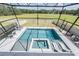 Screened-in pool area with a modern pool, integrated spa, and ample lounge seating for relaxation and entertainment at 14507 Woodland Spur Dr, Lithia, FL 33547