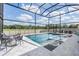 Stunning screened-in pool with a spa, surrounded by lounge seating perfect for relaxation at 14507 Woodland Spur Dr, Lithia, FL 33547