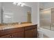 Bathroom with a granite countertop, wooden cabinets, and a glass-door shower at 16030 Bella Woods Dr, Tampa, FL 33647