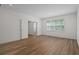 Bedroom featuring wood-look floors and plenty of natural light at 16030 Bella Woods Dr, Tampa, FL 33647