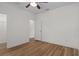 Bedroom with wood-look floors, ample closet space, and neutral paint at 16030 Bella Woods Dr, Tampa, FL 33647