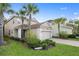 Two-story home featuring a two-car garage, well-manicured landscaping, and a brick-paved driveway at 16030 Bella Woods Dr, Tampa, FL 33647