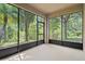 Screened-in patio offers views of the lush and tropical greenery surrounding the property at 16030 Bella Woods Dr, Tampa, FL 33647