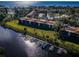 An aerial shot reveals a waterfront condo complex with docks and a pool, offering scenic views at 1686 Seascape Cir, Tarpon Springs, FL 34689
