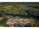 Aerial view of condo building showcasing waterfront living with convenient boat docks and lush landscape at 1686 Seascape Cir, Tarpon Springs, FL 34689