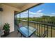 Scenic balcony with seating provides a serene retreat overlooking a river and lush landscape at 1686 Seascape Cir, Tarpon Springs, FL 34689