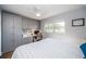 Cozy bedroom features custom built-in cabinets and a work space with a window view at 1686 Seascape Cir, Tarpon Springs, FL 34689