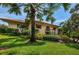 Exterior of home showing well manicured lawn and lush landscaping at 1686 Seascape Cir, Tarpon Springs, FL 34689
