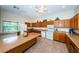 Bright kitchen featuring ample cabinet space, large island, and modern white appliances at 1686 Seascape Cir, Tarpon Springs, FL 34689