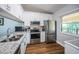 Bright kitchen featuring stainless steel appliances, granite countertops, and modern cabinetry at 1686 Seascape Cir, Tarpon Springs, FL 34689
