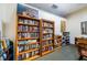 Cozy library featuring built-in wooden bookshelves with carpeting at 1686 Seascape Cir, Tarpon Springs, FL 34689