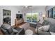 Living room with a ceiling fan and sliding glass doors to a beautiful outdoor balcony with lake views at 1686 Seascape Cir, Tarpon Springs, FL 34689