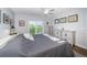 Bedroom with a ceiling fan and sliding glass doors to a beautiful outdoor balcony with lake views at 1686 Seascape Cir, Tarpon Springs, FL 34689