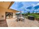 Outdoor patio featuring brick flooring, a dining table and chairs, and a grill at 1686 Seascape Cir, Tarpon Springs, FL 34689