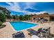 Inviting community pool area with lounge chairs and clear blue water for relaxing summer days at 1686 Seascape Cir, Tarpon Springs, FL 34689