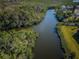 A serene river winds through lush green trees, offering a tranquil escape into nature at 1686 Seascape Cir, Tarpon Springs, FL 34689